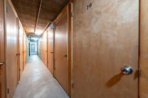 Hallway featuring concrete flooring