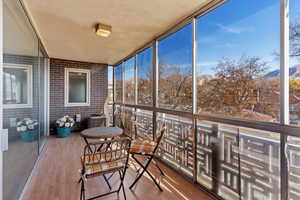 Sunroom / solarium featuring a mountain view and a balcony