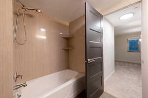 Full bathroom with  shower combination and light carpet