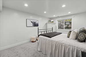 Carpeted bedroom with recessed lighting and baseboards
