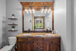Bathroom with double vanity and toilet