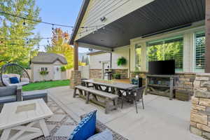 View of patio / terrace with outdoor dining area, a storage unit, and outdoor lounge area