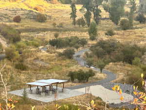 View of home's community featuring a patio and a view of countryside