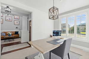 Office area with a chandelier and baseboards