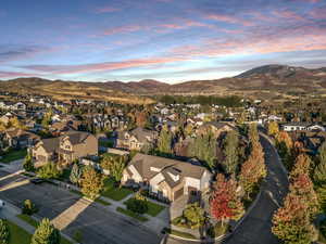 Aerial overview of property's location with a mountain backdrop and nearby suburban area