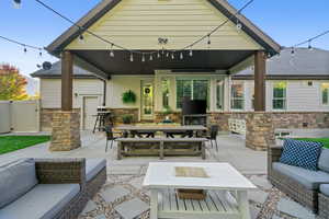 View of patio / terrace with outdoor dining area, a grill, a gate, and an outdoor hangout area