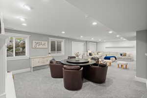 Dining room with light carpet and recessed lighting