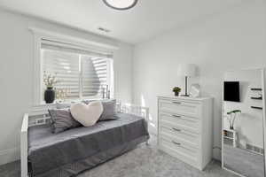 Bedroom with light carpet