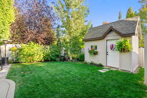 Fenced backyard with a storage unit