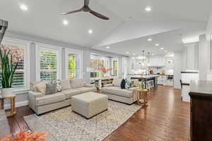 Living area featuring lofted ceiling, dark wood-type flooring, recessed lighting, and a ceiling fan