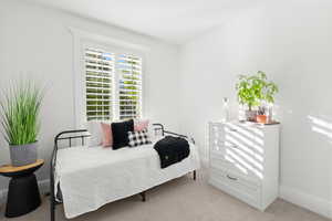 Carpeted bedroom with baseboards