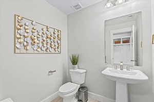 Bathroom with baseboards and toilet
