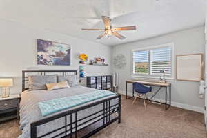 Bedroom with carpet flooring and a ceiling fan