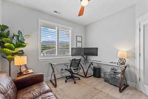 Office space featuring light wood-style flooring and a ceiling fan