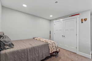 Bedroom featuring carpet floors, recessed lighting, and a closet