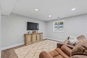 Living room with light colored carpet and recessed lighting
