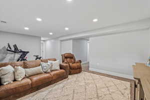 Carpeted living room featuring recessed lighting and baseboards
