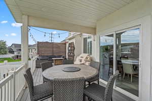 Wooden terrace featuring outdoor dining space and outdoor lounge area