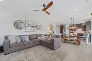 Living room featuring recessed lighting, light wood-style floors, and ceiling fan