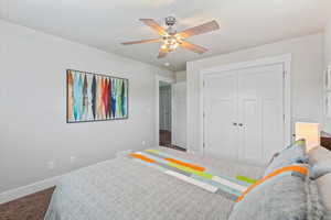 Bedroom with carpet, a closet, and ceiling fan