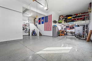 Garage featuring freestanding refrigerator