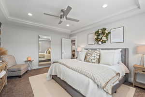 Bedroom featuring a raised ceiling, a ceiling fan, recessed lighting, and dark colored carpet