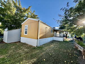 View of property exterior featuring a lawn