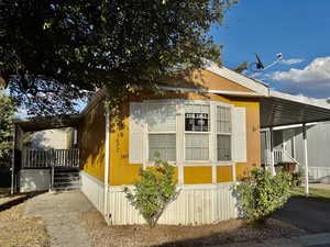 View of property exterior with a carport