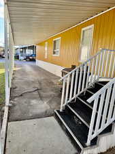 Covered porch featuring a carport