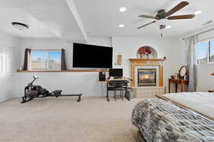 Bedroom or Family room, recessed lighting, a tiled fireplace, and a ceiling fan