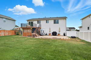 Back of house featuring stairway, a patio area, a fenced backyard, and a deck