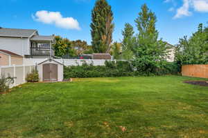 Fenced backyard with a shed