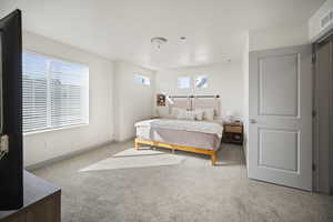 Bedroom featuring carpet flooring and baseboards