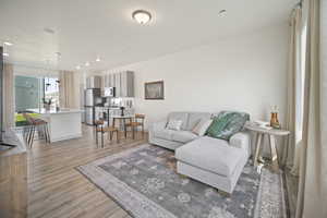 Living room featuring light wood-style floors and recessed lighting