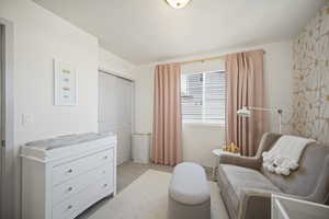 Living area featuring light colored carpet