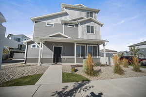 View of front of house featuring covered porch and board and batten siding