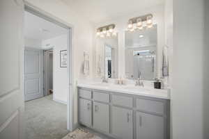 Full bath with a shower stall and double vanity