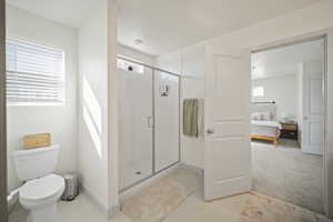 Bathroom featuring a stall shower, ensuite bath, and light tile patterned floors