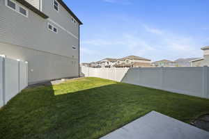Fenced backyard with a residential view and a patio area