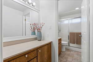 Full bathroom with vanity and a shower stall