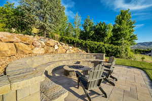 View of patio / terrace with a fire pit and a mountain view