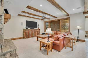 Living area with light carpet, beam ceiling, recessed lighting, and ceiling fan