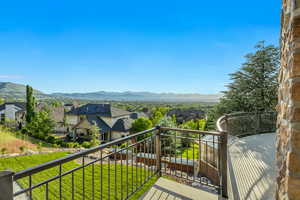 Balcony featuring a residential view and a mountain view