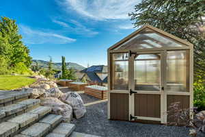 View of greenhouse featuring a vegetable garden and a mountain view