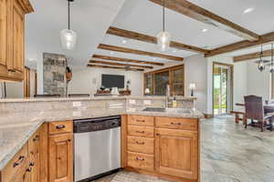 Kitchen with open floor plan, decorative light fixtures, dishwasher, recessed lighting, and beam ceiling