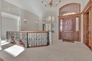 Foyer featuring a chandelier, high vaulted ceiling, and recessed lighting