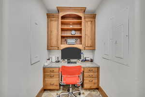 Office area with built in study area and electric panel