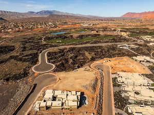 Aerial view of residential area featuring a water and mountain view and a golf course