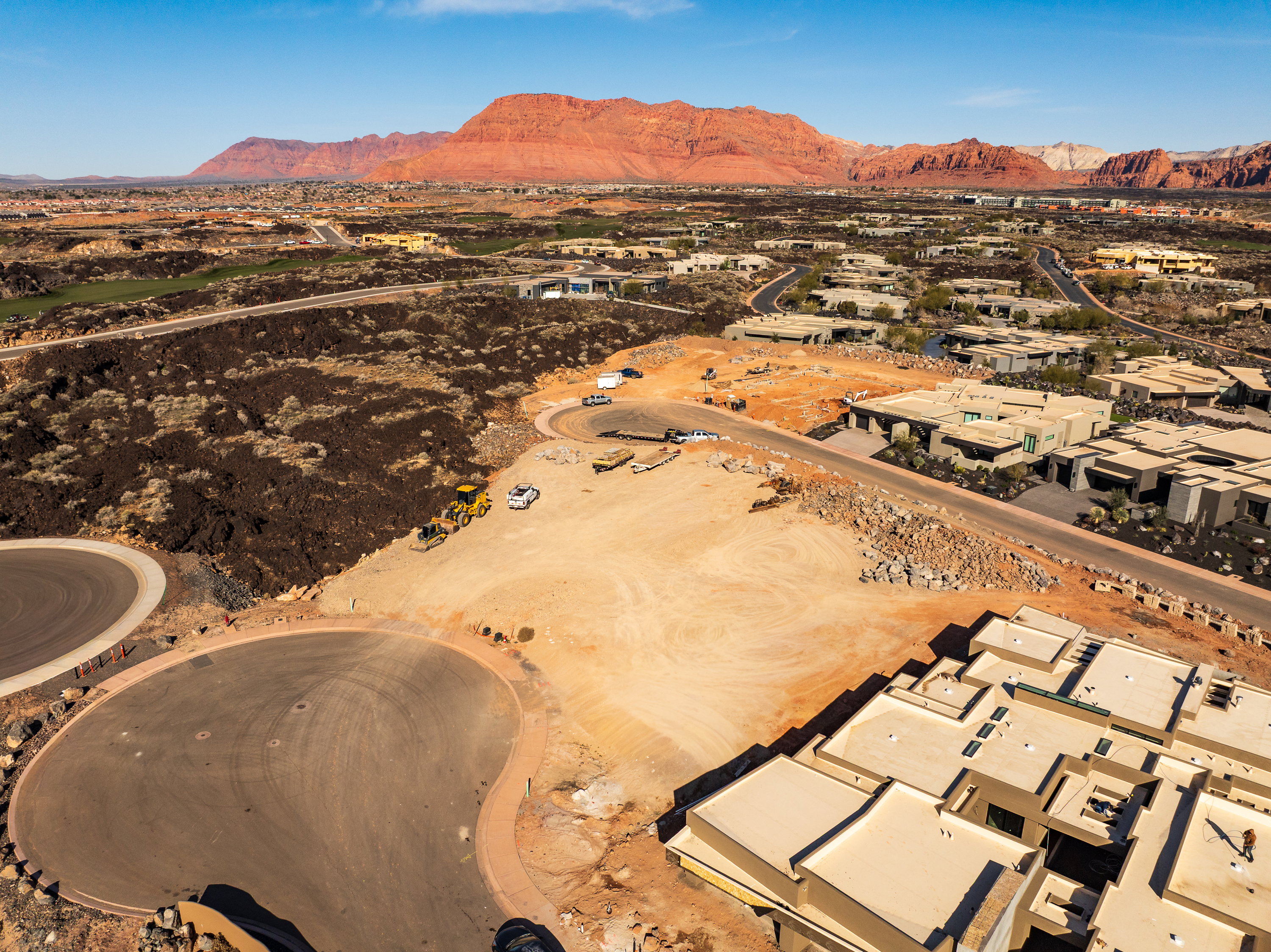 Aerial view of residential area with a mountainous background and a desert landscape