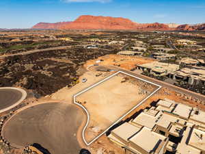Aerial view of residential area featuring a mountainous background and a desert landscape